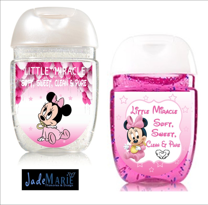May include: Two clear plastic bottles of hand sanitizer with pink labels featuring a cartoon image of Minnie Mouse. The labels read "Little Miracle Soft, Sweet, Clean & Pure".
