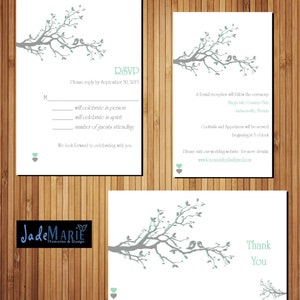 May include: RSVP card with a gray branch with green leaves and two birds. The card has a white background and the text "RSVP" in black. The text "Please reply by September 30, 2015" is also in black. The card has a line for the guest to indicate if they will celebrate in person, in spirit, or the number of guests attending. The card also has a small green heart at the bottom.