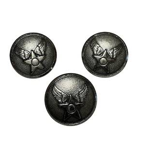 May include: Three circular metal buttons with a dark silver finish. Each button features a raised design of a five-pointed star with a pair of wings extending from the top sides. The surface of the buttons has a textured, slightly weathered appearance.