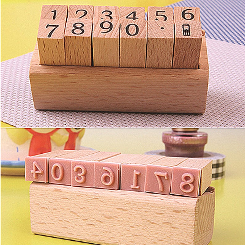May include: A set of ten wooden number stamps in a wooden box. The stamps are arranged in order from 1 to 10. The box is made of light wood and has a natural finish. The stamps are used for stamping numbers on paper, fabric, or other surfaces.