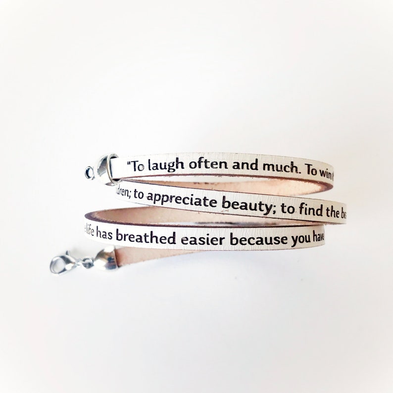 May include: White leather bracelet with a quote from the book "To Kill a Mockingbird" by Harper Lee: "To laugh often and much. To win friends; to appreciate beauty; to find the best in others; to leave the world a bit better..."