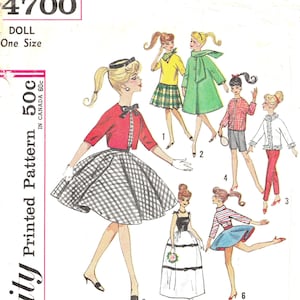 May include: A vintage Simplicity sewing pattern for a doll, featuring six different outfits. The pattern is numbered 4700 and costs 50 cents. The outfits include a red jacket with a black and white checkered skirt, a green coat, a red and white checkered shirt with blue shorts, a white blouse with a black and white skirt, a white dress with a black trim, and a blue and white striped shirt with a blue skirt.