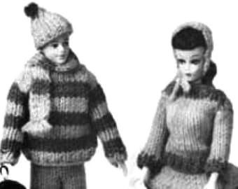 May include: A black and white photo of two dolls wearing knitted clothing. The doll on the left is wearing a striped sweater, a hat, and pants. The doll on the right is wearing a striped sweater and a skirt. Both dolls are holding their hands out in front of them.