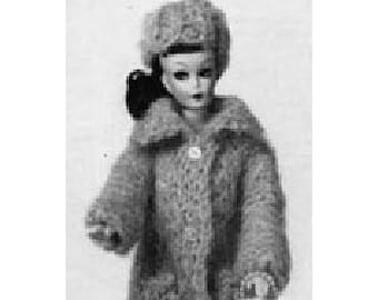 May include: A black and white photo of a doll wearing a fuzzy, brown coat with a matching hat and carrying a small purse.