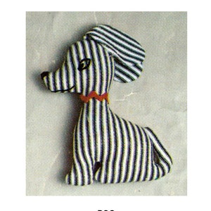 May include: A striped, black and white fabric dog toy with a red and orange collar.