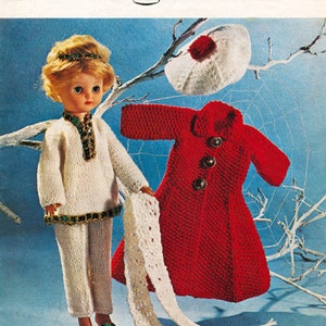 May include: A knitting pattern for a doll outfit, featuring a white sweater, pants, and scarf, a red coat, and a white hat. The pattern is from Bronte, a brand of knitting patterns, and is for double knitting. The pattern number is 625 and the price is 9 pence.
