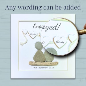 Close up of Personalised Pebble art picture in a white frame to celebrate an engagement