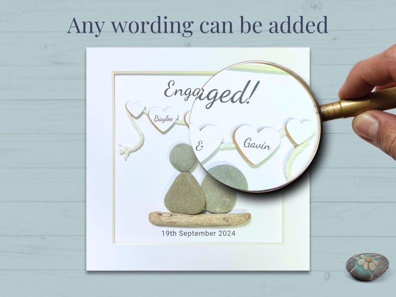 Close up of Personalised Pebble art picture in a white frame to celebrate an engagement