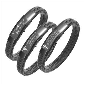 May include: Three black braided bracelets with engraved text. One bracelet says "William Jennifer July 15 2025". Another says "ALLERGIC TO PENICILLIN DIABETIC INSULIN DAVID: 591-123-4567". The third says "PHILIPPIANS 4:13 I CAN DO ALL THINGS THROUGH CHRIST WHO STRENGTHENS ME".