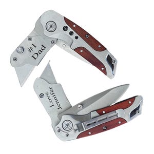 May include: Two pocket knives with wood handles. One knife has the text "#1 Dad" engraved on the handle. The other knife has the text "Love Jennifer" engraved on the handle.