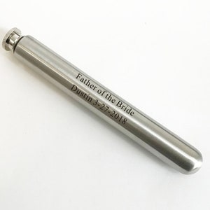 May include: Silver metal flask with an engraved inscription that reads "Father of the Bride Dustin 3-27-2018".