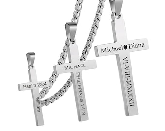 May include: Three silver cross necklaces with engraved names and dates. The largest cross has the names "Michael" and "Diana" with the date "VI-VIII-MMXXII" engraved on it. The middle cross has the name "MICHAEL" and the scripture "PHILIPPIANS 14:3" engraved on it. The smallest cross has the name "William" and the scripture "Psalm 23:4" engraved on it.