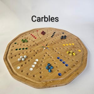 May include: An octagonal bamboo board game titled Carbles with a star-shaped center and numerous circular indentations. The board features sets of colorful glass marbles in green, red, white, blue, yellow, and black arranged in rows.