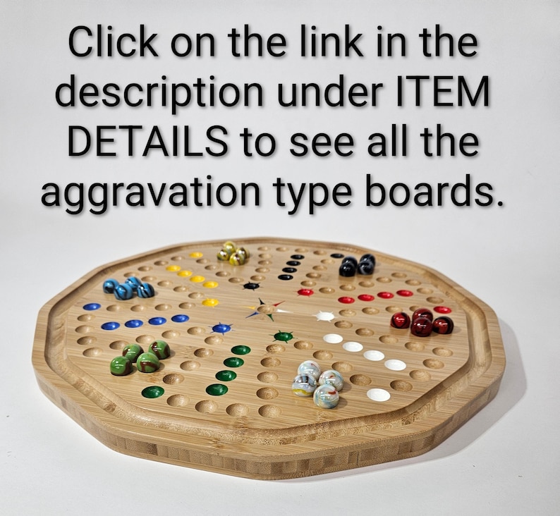 May include: An octagonal wooden board game with circular indentations and colored glass marbles. The text reads: Click on the link in the description under ITEM DETAILS to see all the aggravation type boards.