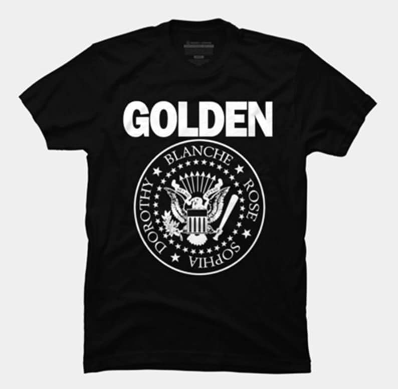 May include: Black t-shirt with a white graphic of the word "GOLDEN" above a stylized presidential seal with the names "DOROTHY, BLANCHE, ROSE, SOPHIA" around the perimeter.