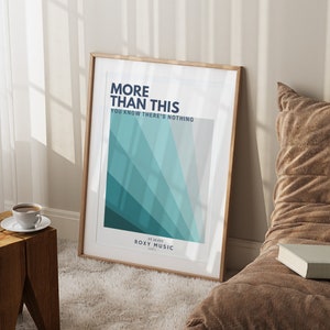 May include: A framed print with a teal and white geometric design. The text "More Than This" is at the top of the print, followed by "You Know There's Nothing." The bottom of the print reads "Avalon Roxy Music 1982."