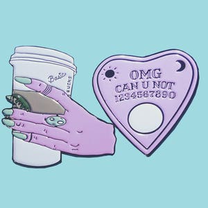 May include: Purple enamel pin set featuring a coffee cup with the text "Basic Bucks" and a purple heart-shaped Ouija board with the text "OMG CAN U NOT 1234567890".