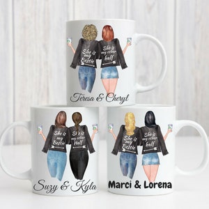 May include: Four white ceramic mugs with black handles. Each mug features a graphic of two women wearing black leather jackets and jeans. The text on the mugs reads "She is my bestie" and "She is my other half". The names of the women are printed below the graphic. The mugs are arranged in two rows of two.