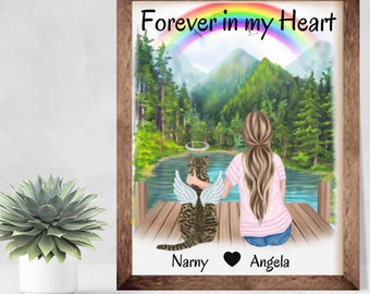 Puede incluir: Una impresión enmarcada con una ilustración de acuarela de una mujer y un gato sentados en un muelle con vistas a un lago. El cielo tiene un arcoíris con las palabras "Forever in my Heart" encima. El gato tiene alas de ángel y un halo. Los nombres "Narny" y "Angela" están escritos debajo de la imagen.