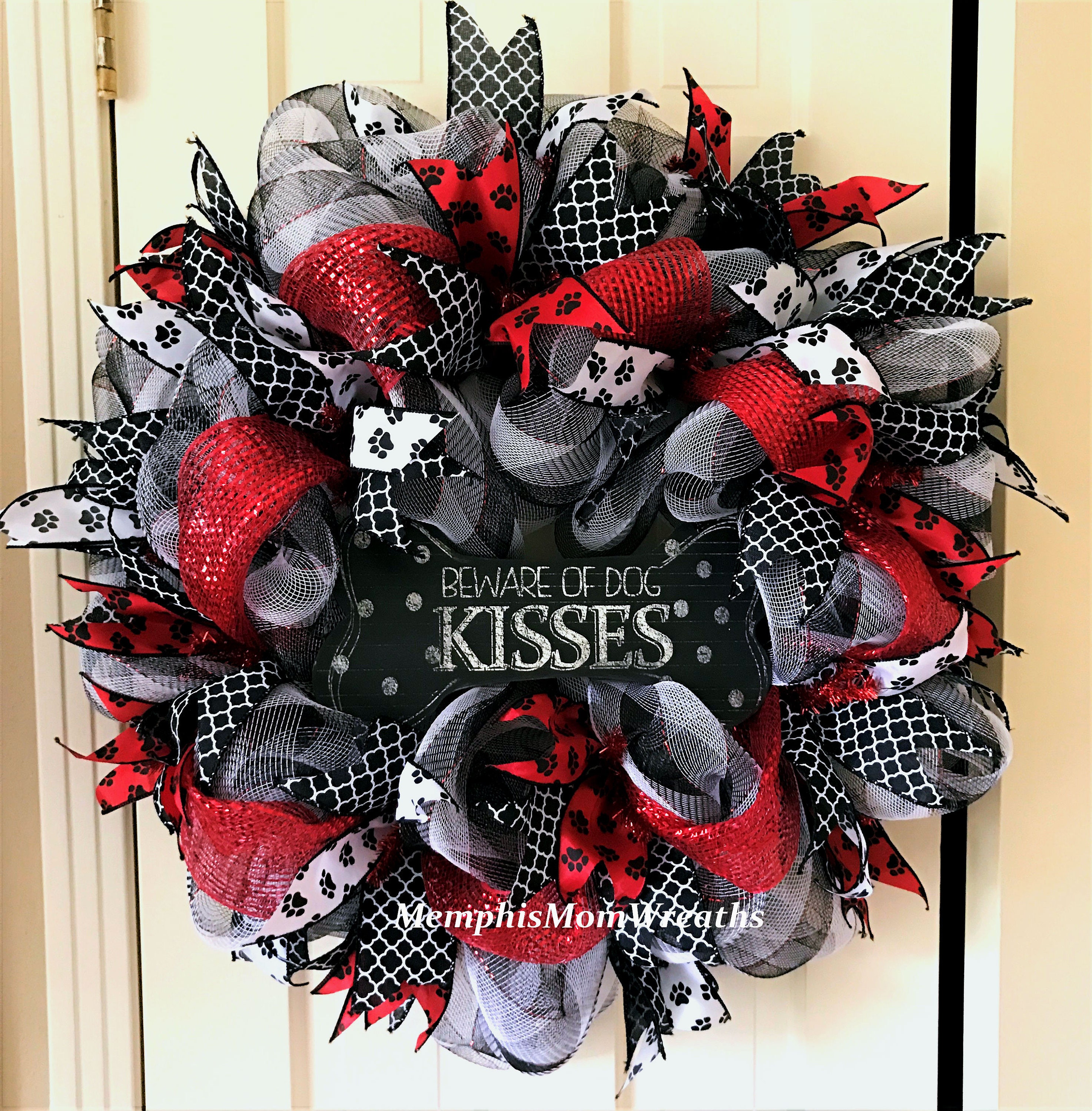 This 24" diameter wreath features 21" black and white plaid with ...