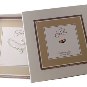 May include: A white gift box with a brown and beige border. The box has a silver bracelet inside and a card that says "For Julia Zur Kommunion am 30.04.2017"  Bloomgart Accessories 925 Sterling Silver.