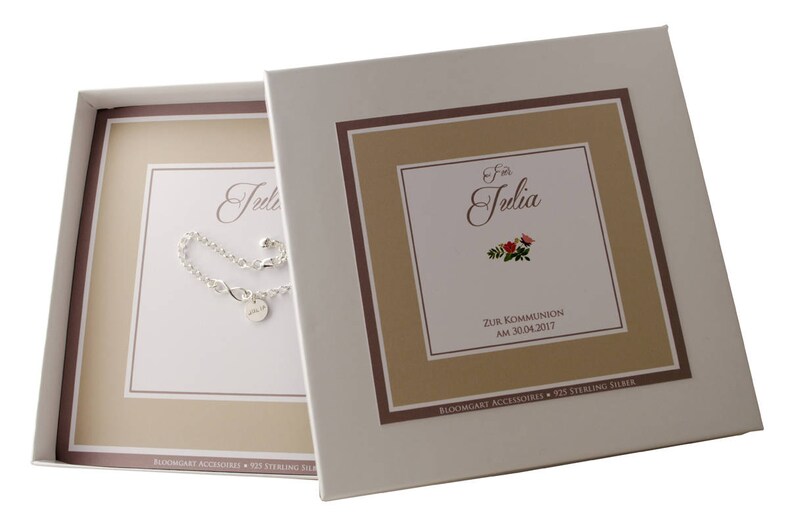 May include: A white gift box with a brown and beige border. The box has a silver bracelet inside and a card that says "For Julia Zur Kommunion am 30.04.2017"  Bloomgart Accessories 925 Sterling Silver.