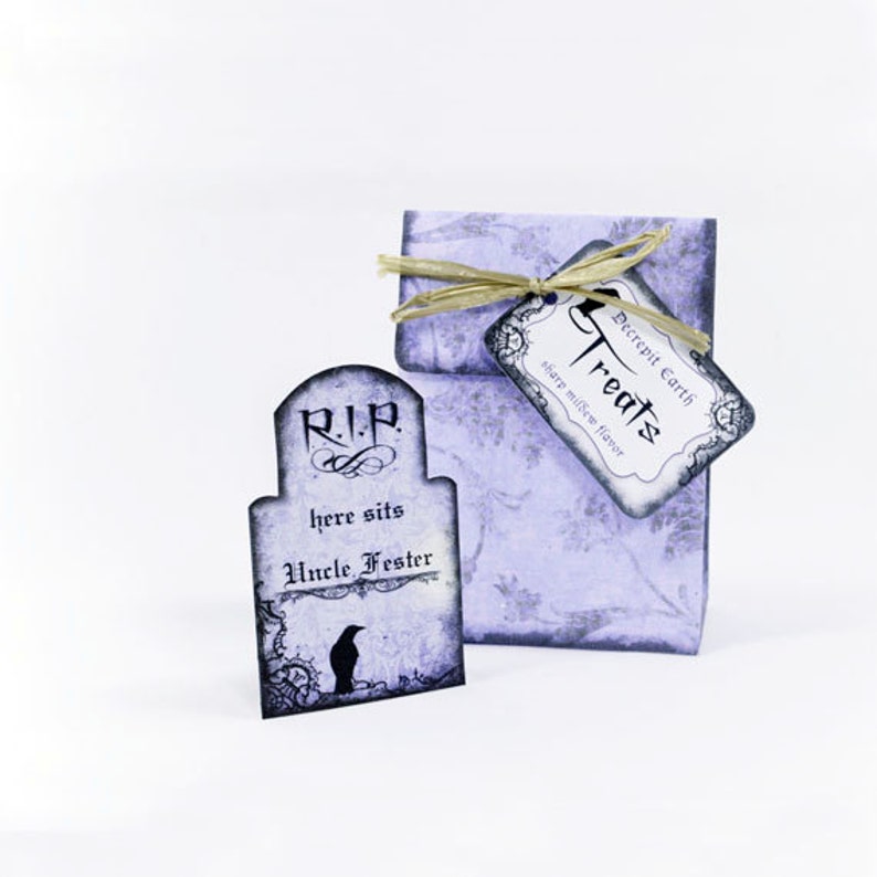 Puede incluir: Una bolsa de golosinas de Halloween de color morado y negro con una etiqueta en forma de l&aacute;pida que dice "R.I.P. here sits Uncle Fester". La bolsa tiene una etiqueta que dice "Decrepit Earth Treats, share marshmallow flavor".