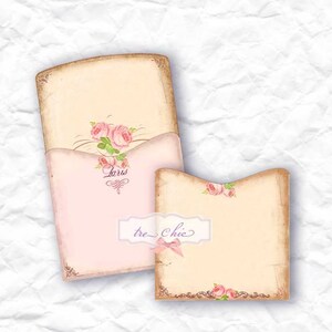 May include: Two vintage-style blank cards with a pink and cream color scheme. The cards feature a floral design with pink roses and green leaves. The larger card has the word "Paris" written on it in a cursive font. The smaller card has the text "tre chic" written on it in a cursive font.