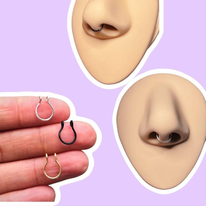 May include: An assortment of nose rings in silver, black, and gold. The image shows the nose rings on a hand and on a mannequin nose. The nose rings are in a U-shape.