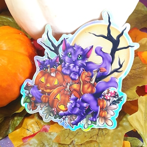 May include: A sticker featuring three purple cats with green eyes, nestled amongst orange and brown jack-o'-lanterns. The cats are surrounded by autumn foliage and mushrooms, with a full moon and bare branches in the background.