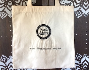 Off White Cotton Tote Bag: Embroidered Logo
