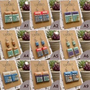 May include: Nine pairs of calculator earrings, each pair featuring a different color scheme. The earrings are made of polymer clay and have a vintage calculator design. The colors include red, blue, green, purple, and brown.