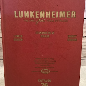 May include: A vintage red catalog titled "LUNKENHEIMER" with gold lettering. The cover includes the text "THE ONE GREAT NAME IN VALVES", "STANDARD VALVE DIVISION", "ENERGY DIVISION", and "CATALOG 76".