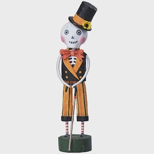 May include: A whimsical Halloween skeleton figurine wearing a black top hat with a sunflower, orange bow tie, and striped pants. The skeleton is holding a cane and standing on a green base. The figurine has a painted face with rosy cheeks.