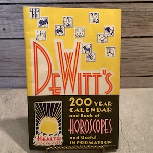 May include: A vintage book cover with the title "DEWITT'S" in large red and orange letters. The cover is yellow with zodiac symbols and the text "200 YEAR CALENDAR and Book of HOROSCOPES and Useful INFORMATION".