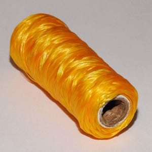 May include: A spool of bright yellow thread.