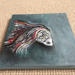 May include: A painting of a white fish with red and black stripes on a teal background.