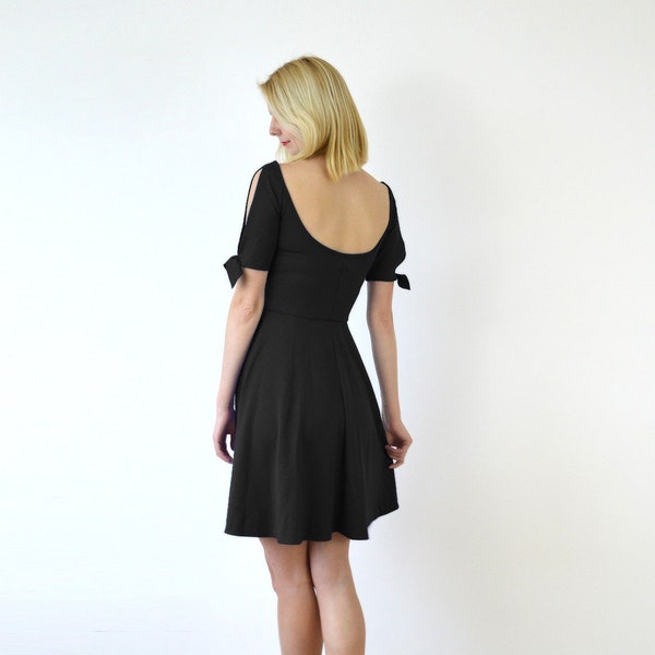 NANETTE | Cut Out Skater Dress with Tied Up Split Sleeves in Black. Wide Neckline Dress with Circular Skirt and Tie-Up Bows