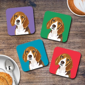 May include: Four square coasters featuring a beagle dog illustration. Each coaster has a different background colour: purple, green, blue, and red.