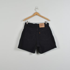 May include: Black denim shorts with a brown leather Levi's patch on the back pocket.