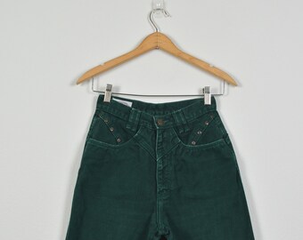 May include: A pair of dark green high-waisted jeans with a button fly and a unique design on the back pockets.