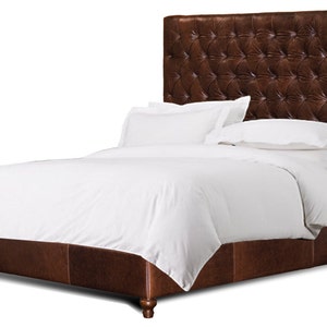 May include: A brown leather upholstered bed frame with a tufted headboard and a white duvet and pillows.
