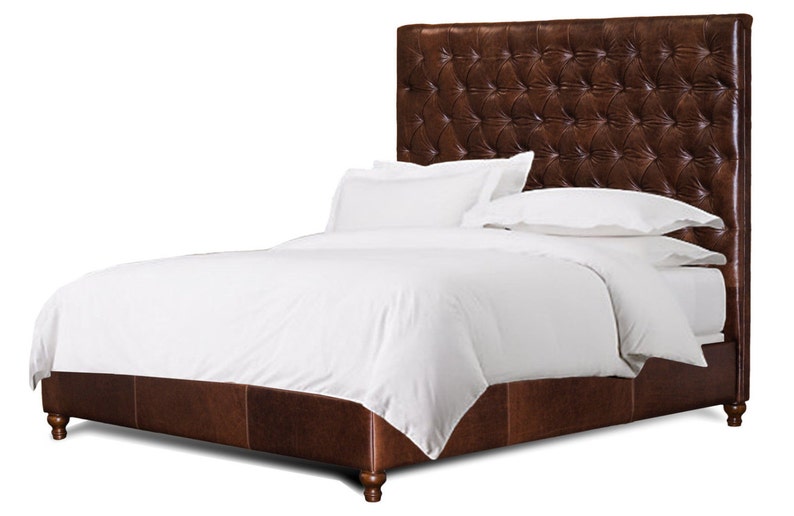 May include: A brown leather upholstered bed frame with a tufted headboard and a white duvet and pillows.