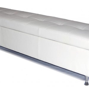 May include: White leather storage bench with tufted upholstery and silver legs.
