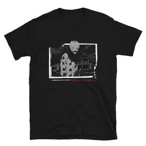 May include: Black t-shirt with a white graphic of a person in a polka dot shirt. The graphic is in a black frame with the text "HELL HOUSE LLC" below it.
