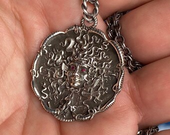 The Medusa sterling silver ancient antique finish with ruby eyes