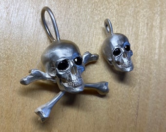 Skulls sterling silver and black zirconium eyes available in multiple sizes and two styles skull and bones and skull only