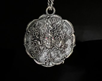 The Medusa sterling silver light antique finish with ruby eyes by Sal Knight © 50 millimeters wide, 2 inches