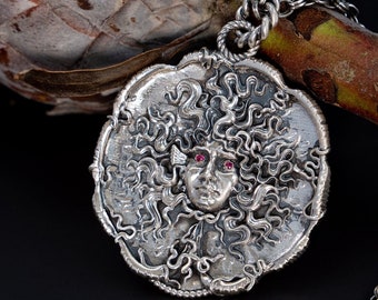 The Medusa sterling silver light antique finish with ruby eyes by Sal Knight © 40 millimeters wide, 1,6 inches