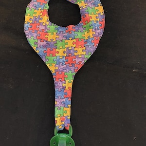 Binky Bib Pacifier Holder - Colorful Puzzle Pieces Pattern